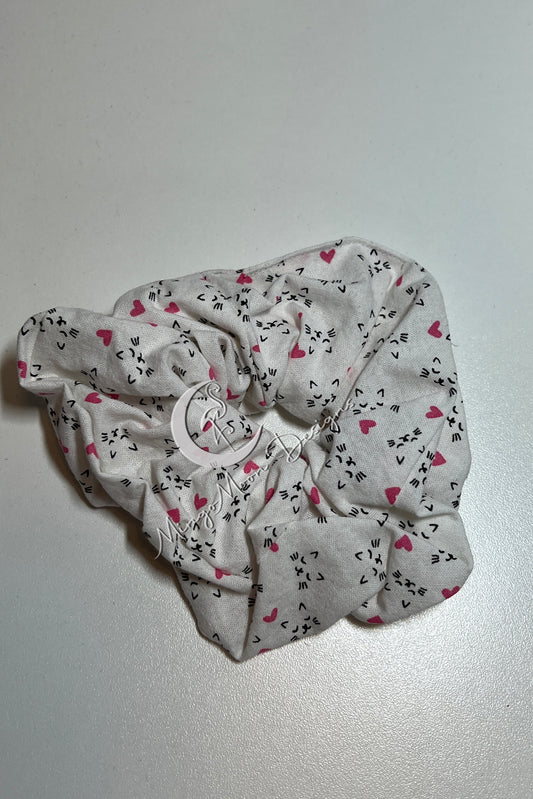 white fabric with little kitty faces and pink hearts