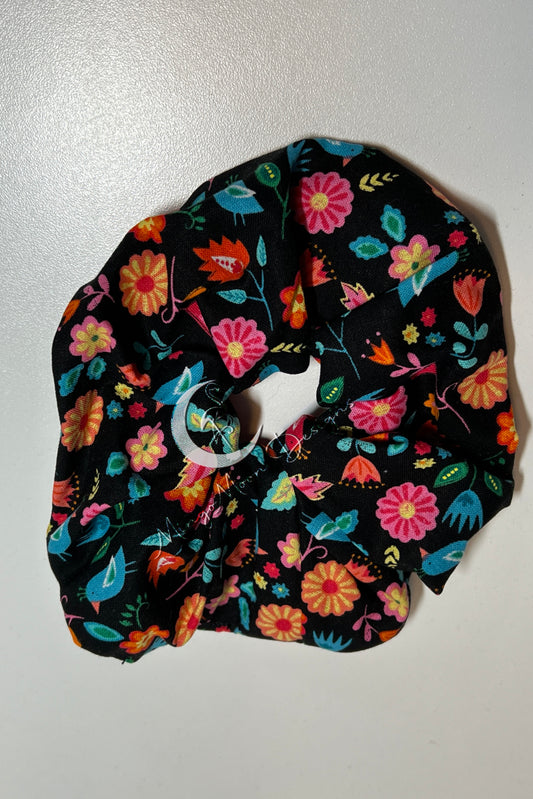 black fabric with bright colorful flowers scrunchie