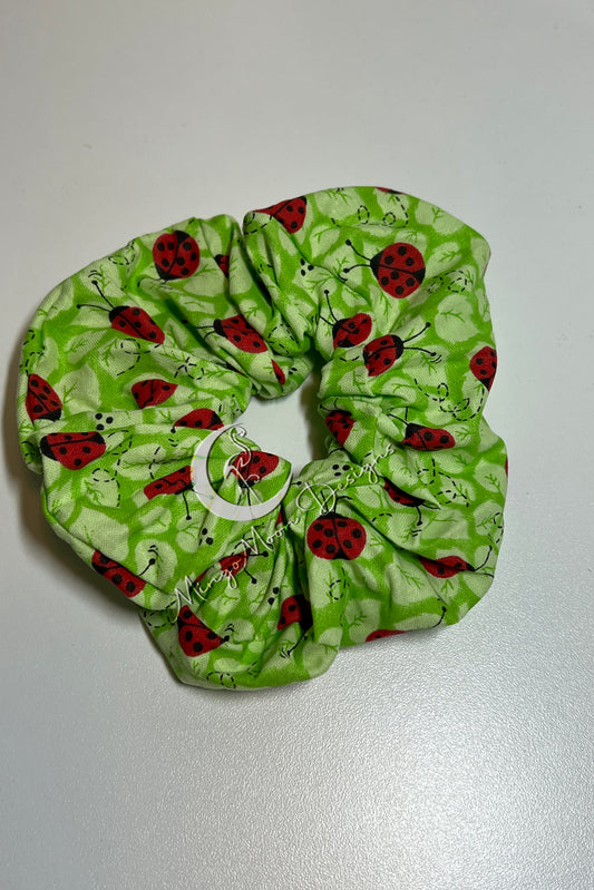 green fabric with leaves and ladybugs