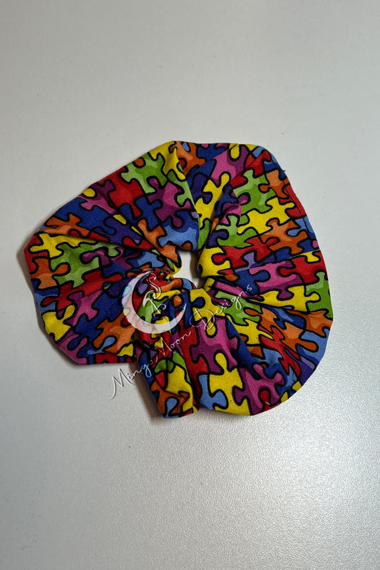 Scrunchie with  bright colorful puzzle pieces 