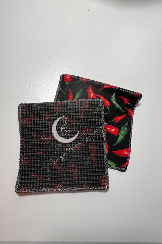 black fabric with red and green hot peppers and a slip grip back jar opener