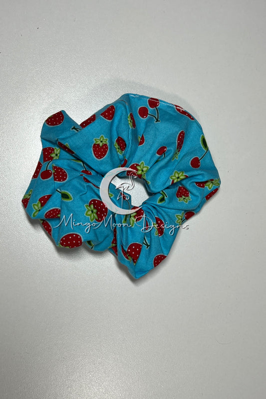 Blue fabric with cherries and strawberries scrunchie