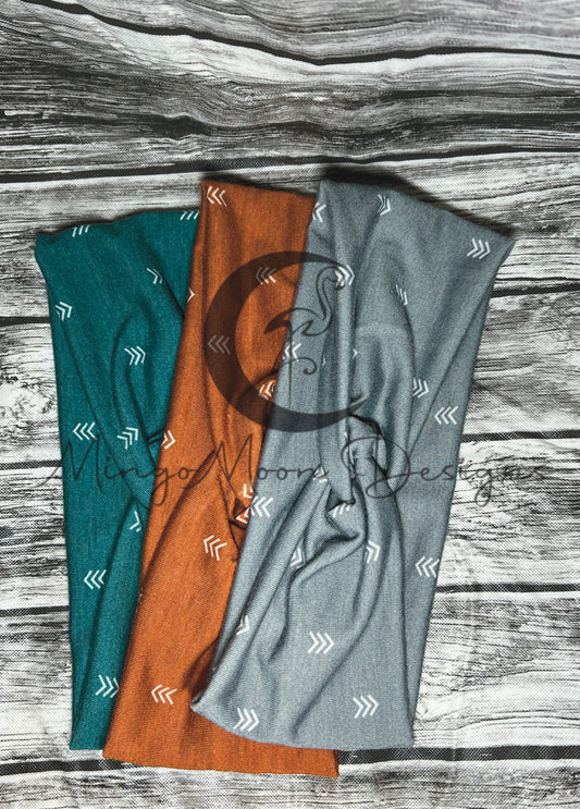 Twisted headband in the colors in Teal, Rust and Gray.